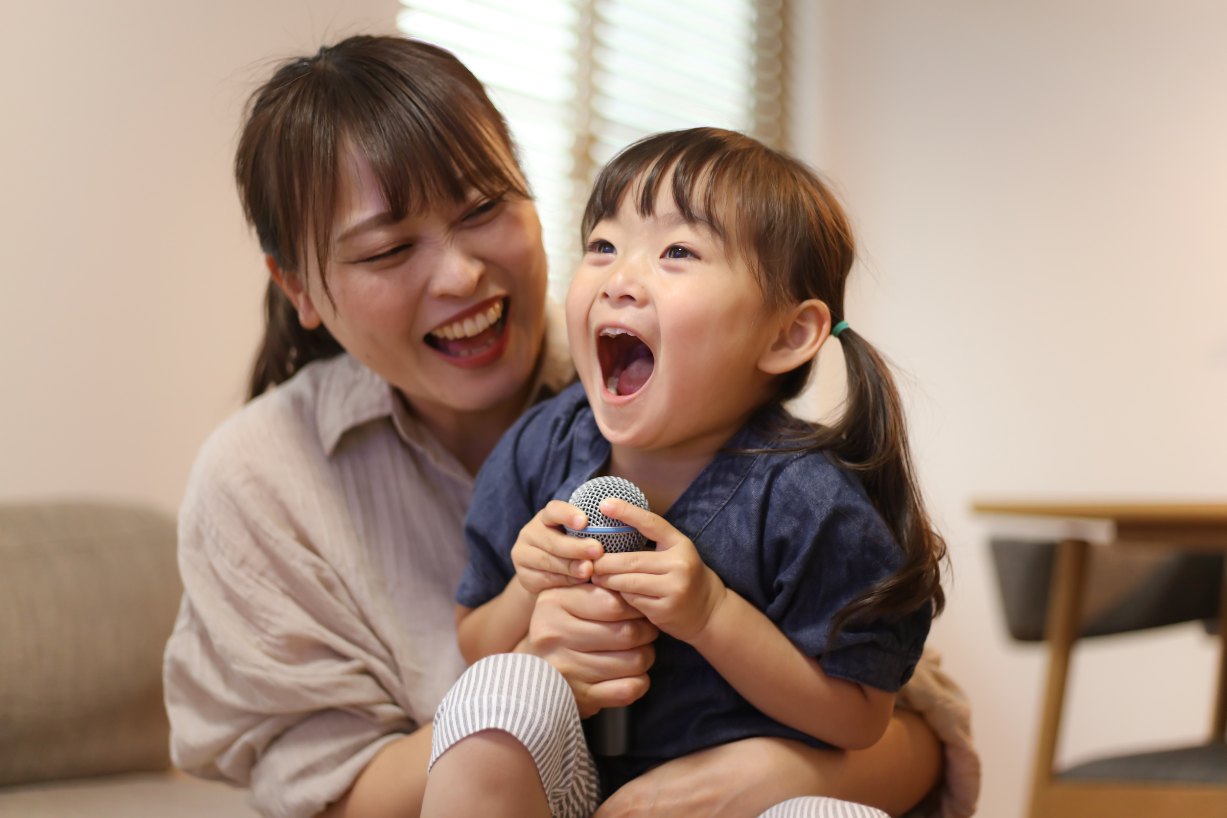 Parents and children enjoying karaoke at home